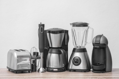 Photo of Kitchen appliances on table against light background. Interior element