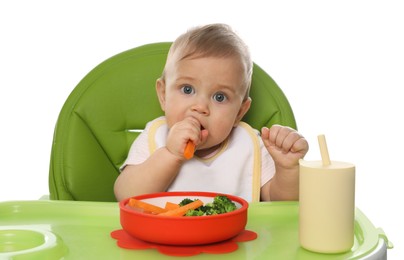 Photo of Cute little baby wearing bib while eating on white background