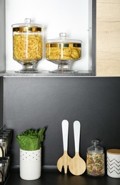 Photo of Products and kitchen utensils on modern shelving unit