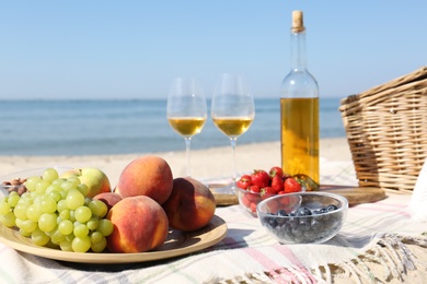 Photo of Food and wine on beach. Summer picnic