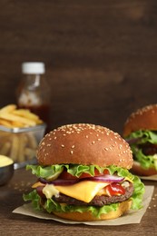 Photo of Delicious burgers with beef patty on wooden table