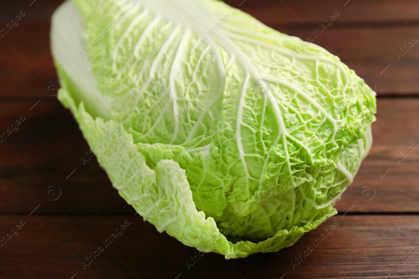 Photo of Fresh ripe Chinese cabbage on wooden table, closeup