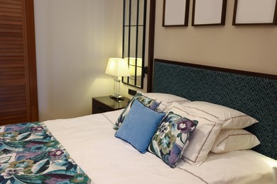 Large bed with pillows and linens in comfortable hotel room