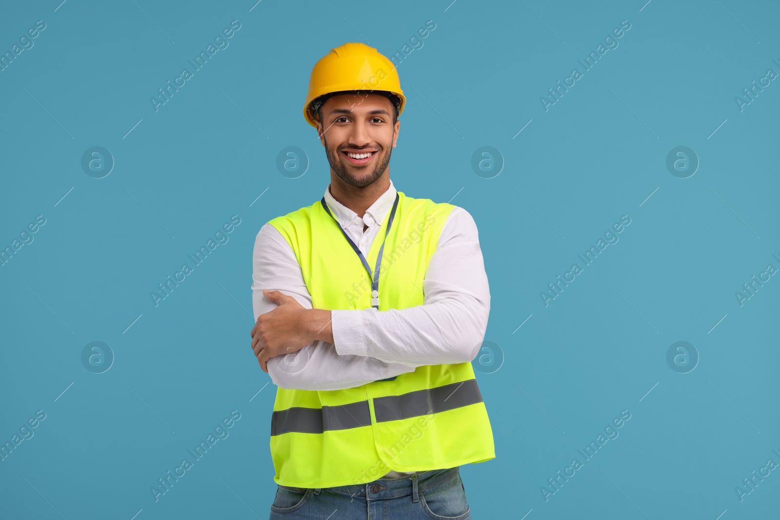 Photo of Engineer in hard hat on light blue background