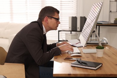 Man with bad posture working on computer in office