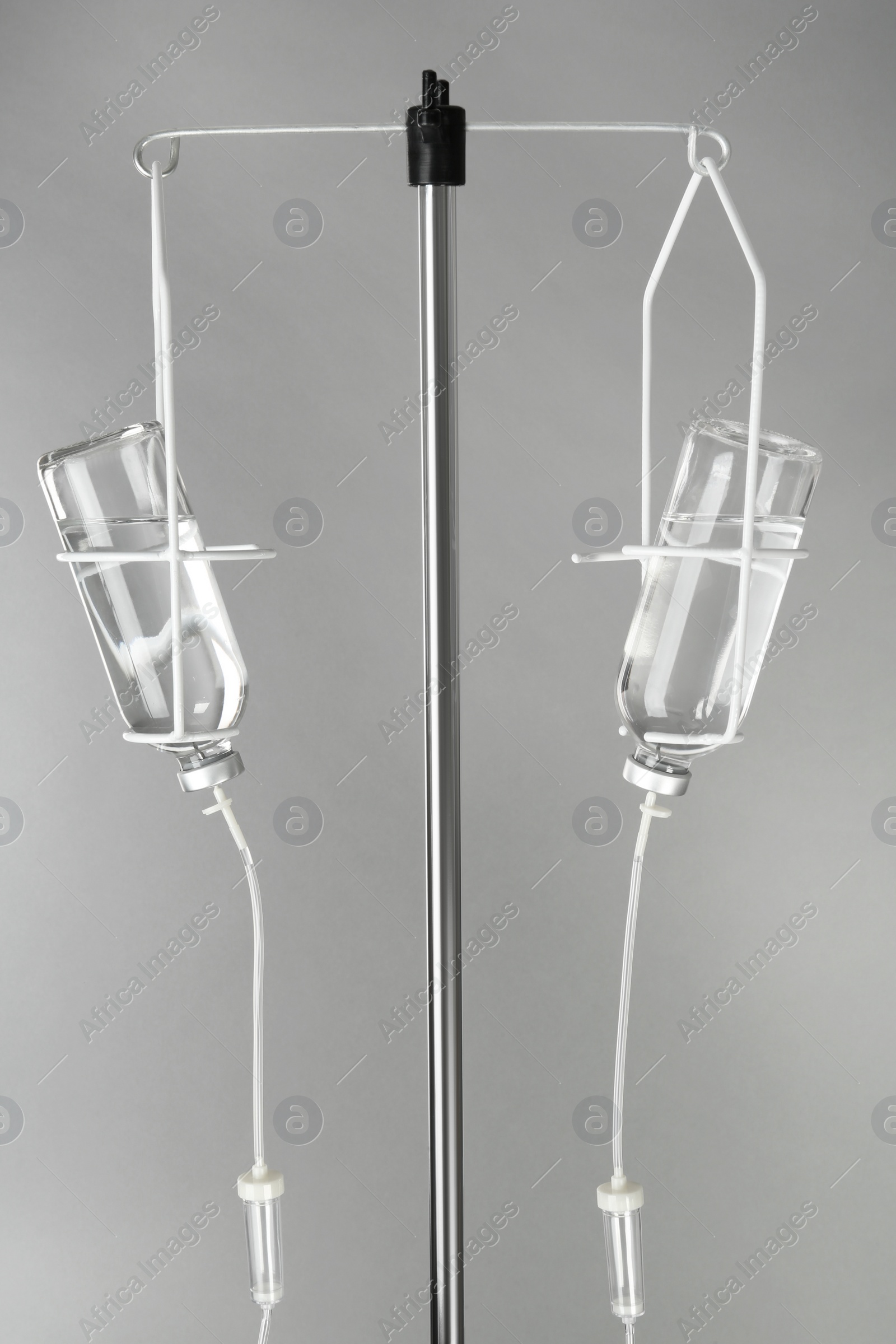 Photo of Drop counter with bottles of medicine on grey background