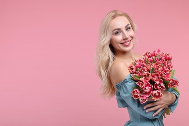 Photo of Happy young woman with beautiful bouquet on dusty pink background. Space for text