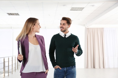 Photo of Real estate agent with client in new apartment. Space for text