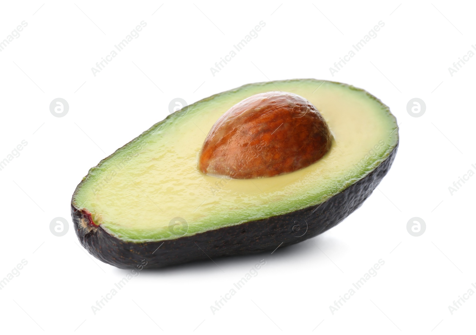 Photo of Half of ripe avocado with pit isolated on white