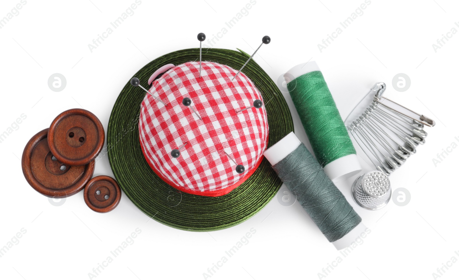 Photo of Pincushion, pins and other sewing tools isolated on white, top view