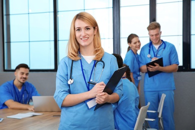 Medical student with groupmates in university library