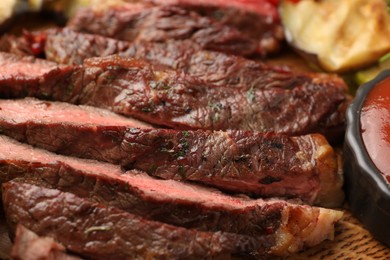 Photo of Delicious grilled beef steak with spices on table, closeup