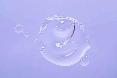 Photo of Sample of cleansing gel on violet background, top view. Cosmetic product