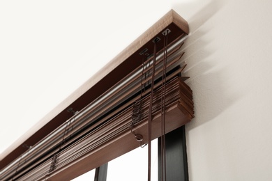 Photo of Modern window with stylish wooden blinds indoors