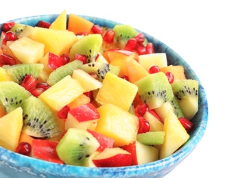 Photo of Bowl with fresh cut fruits on white background