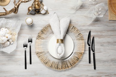 Photo of Easter table setting with bunny ears made of egg and napkin, flat lay