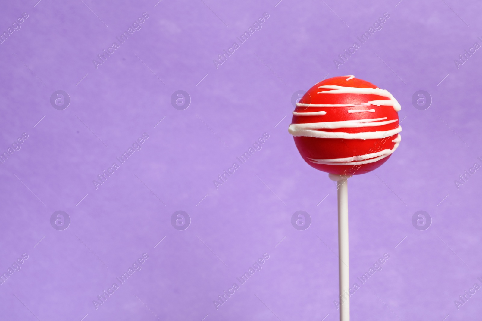 Photo of Bright delicious cake pop on color background. Space for text