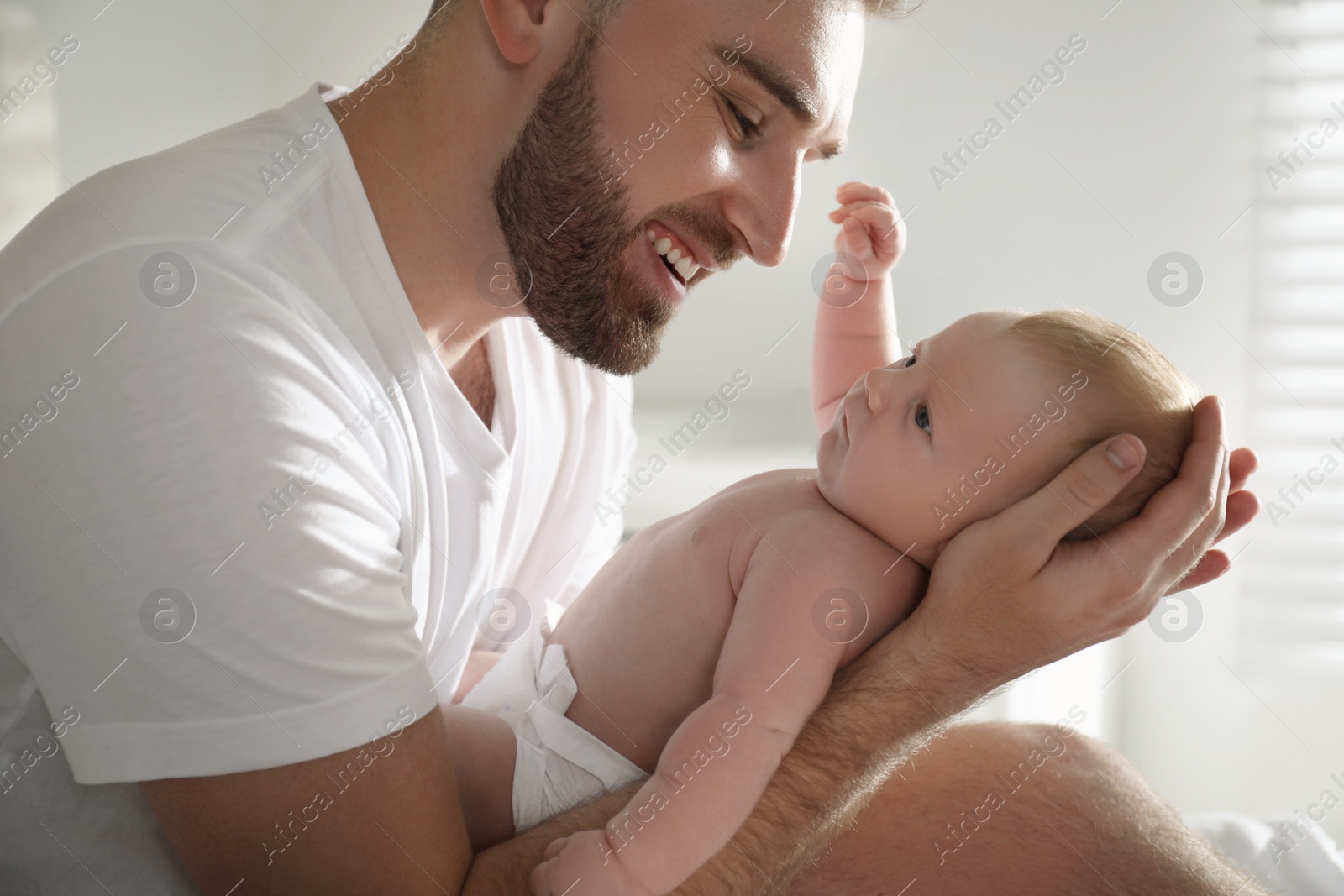 Photo of Father with his newborn son at home, closeup