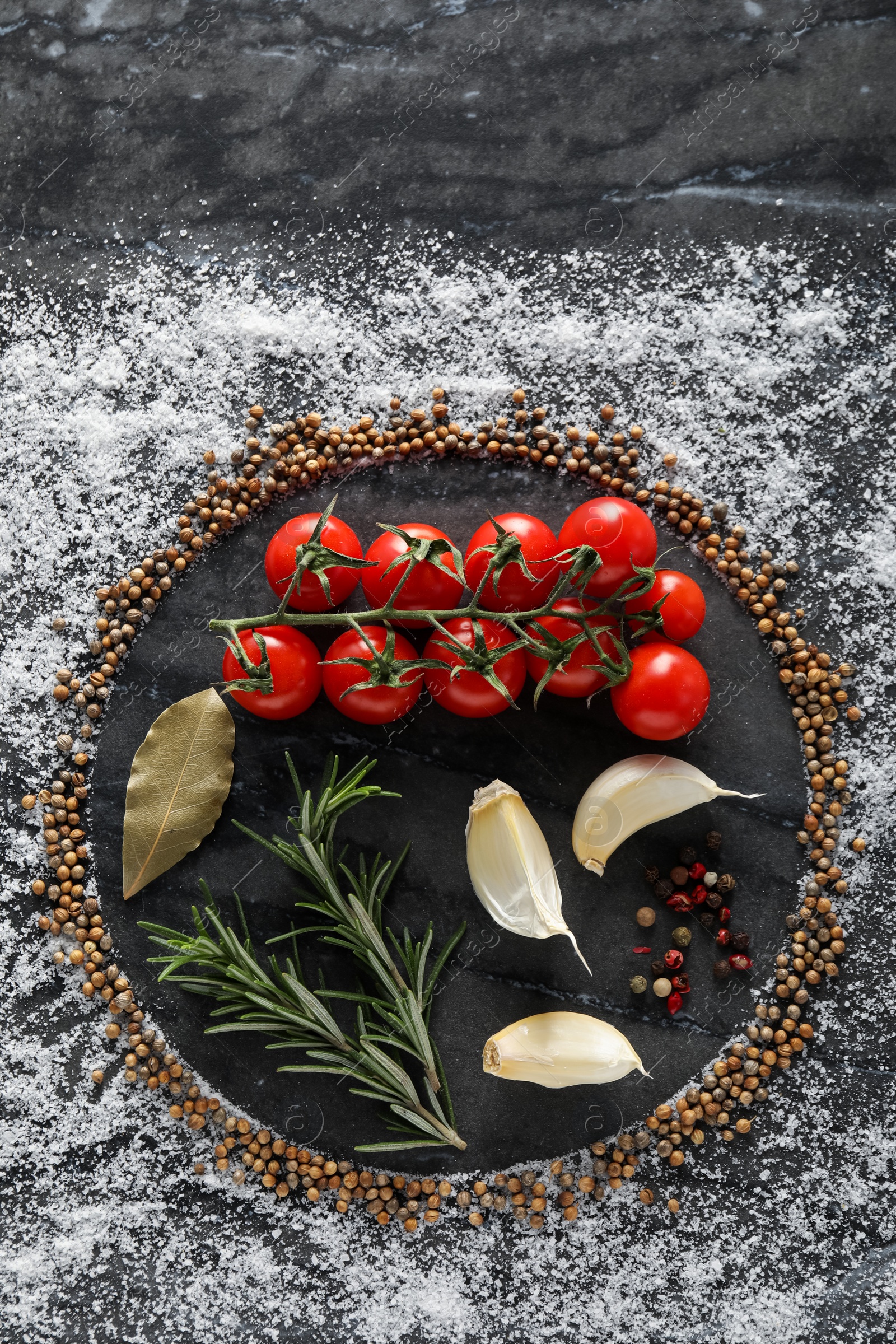 Photo of Flat lay composition with different spices and silhouettes of plate on grey marble background