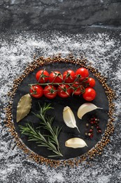 Flat lay composition with different spices and silhouettes of plate on grey marble background