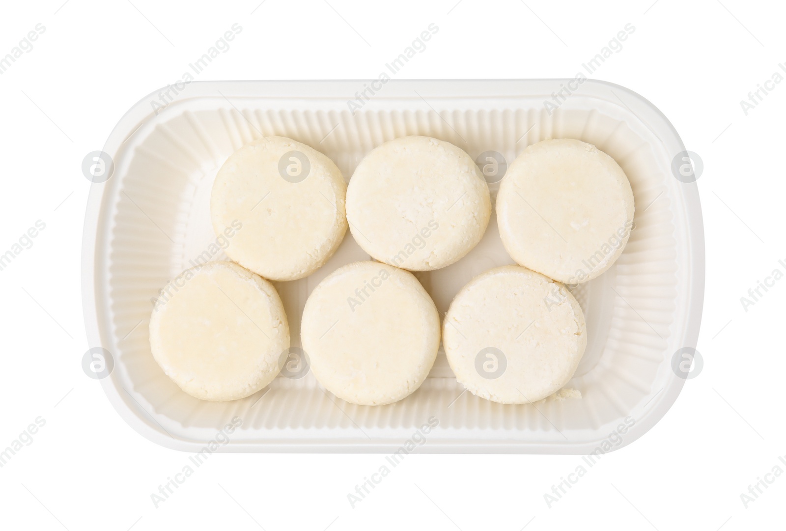 Photo of Container with uncooked cottage cheese pancakes isolated on white, top view