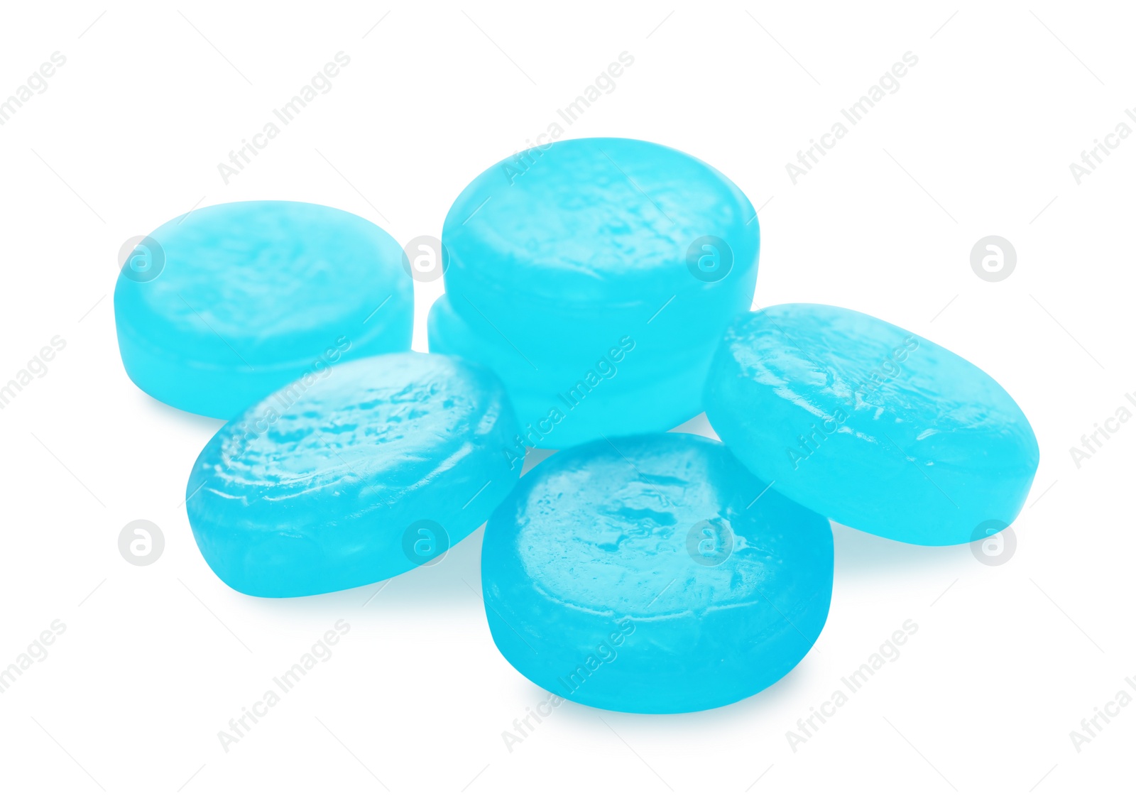 Photo of Many light blue cough drops on white background