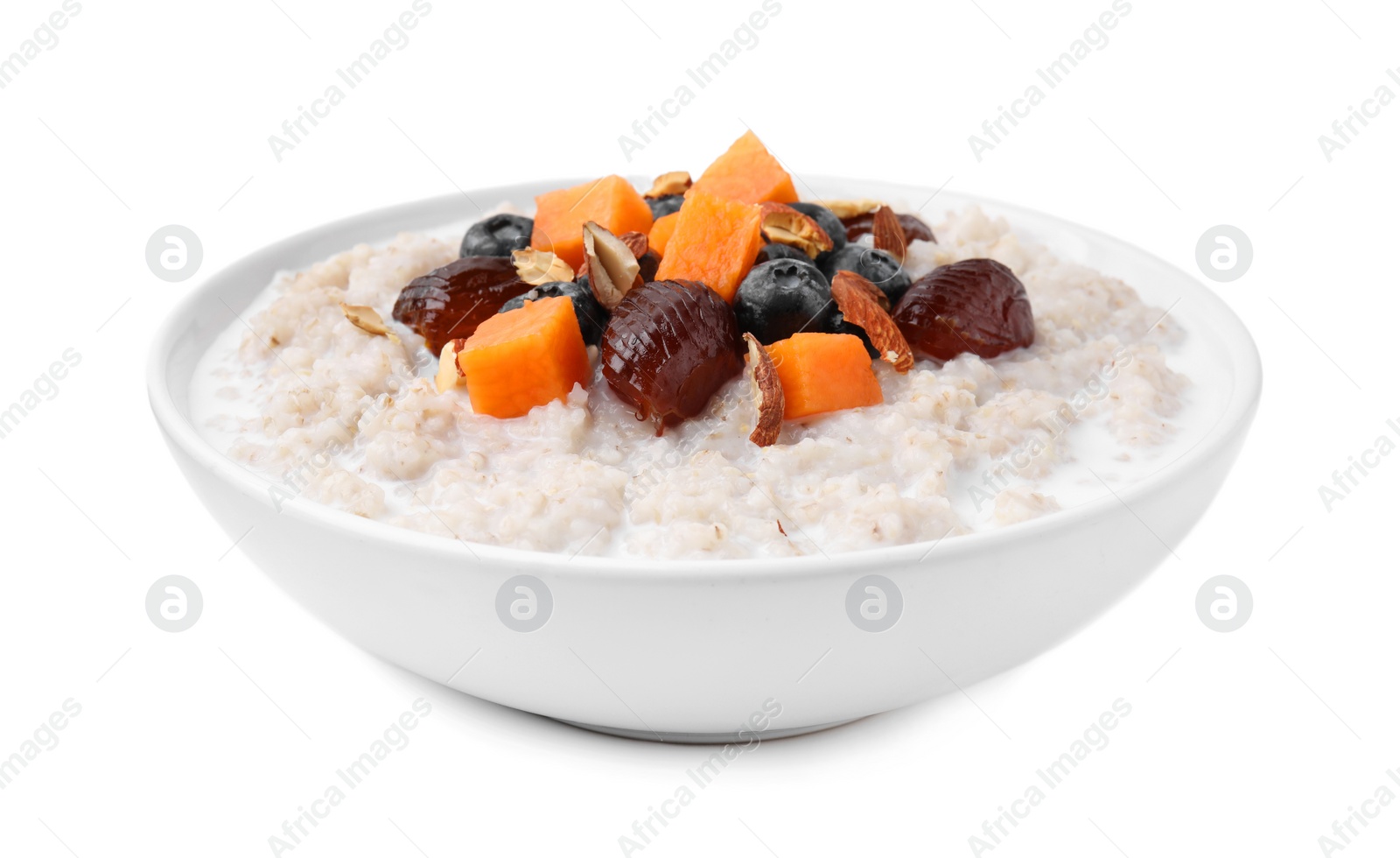 Photo of Delicious barley porridge with blueberries, pumpkin, dates and almonds in bowl isolated on white