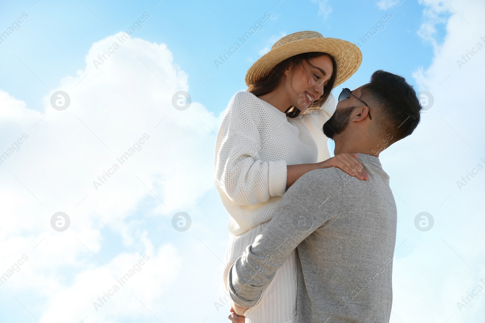 Photo of Happy young couple against blue sky. Honeymoon trip