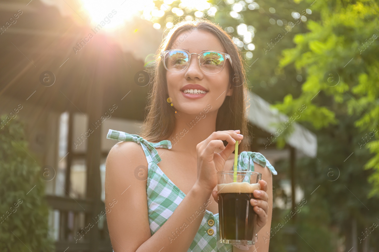 Photo of Young woman with cold kvass outdoors. Traditional Russian summer drink