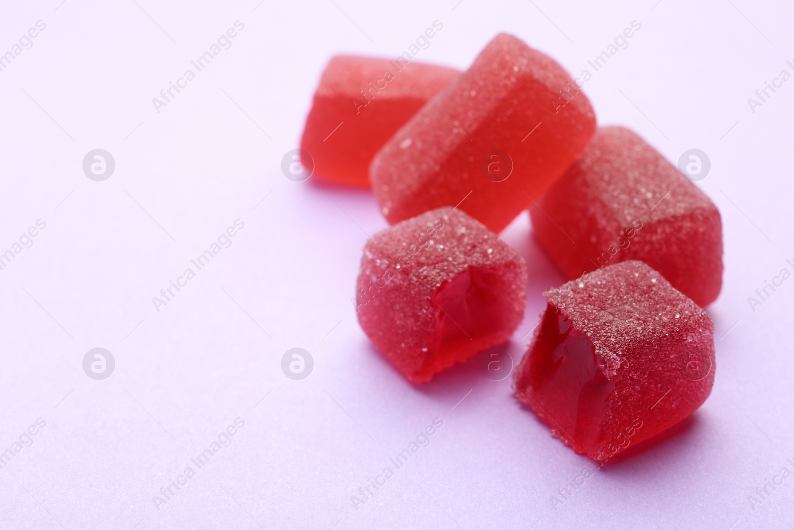 Photo of Tasty jelly candies on color background, space for text