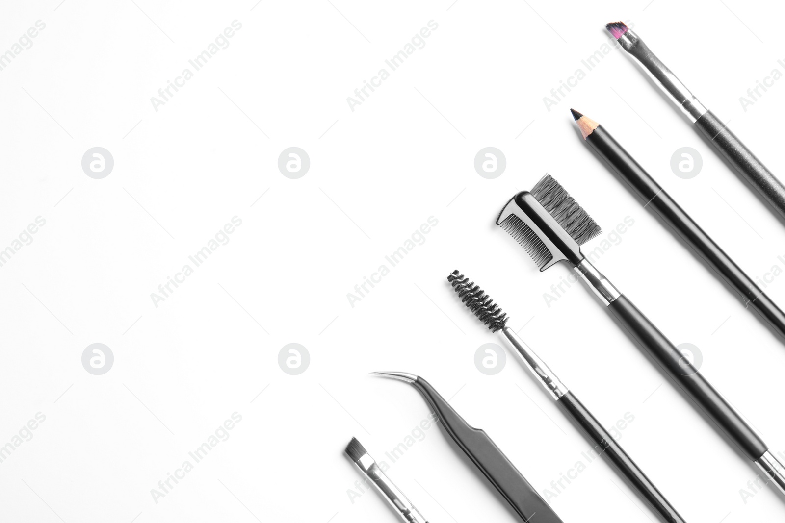Photo of Set of professional eyebrow tools on white background, top view