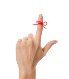 Photo of Woman showing index finger with tied red bow as reminder on white background, closeup