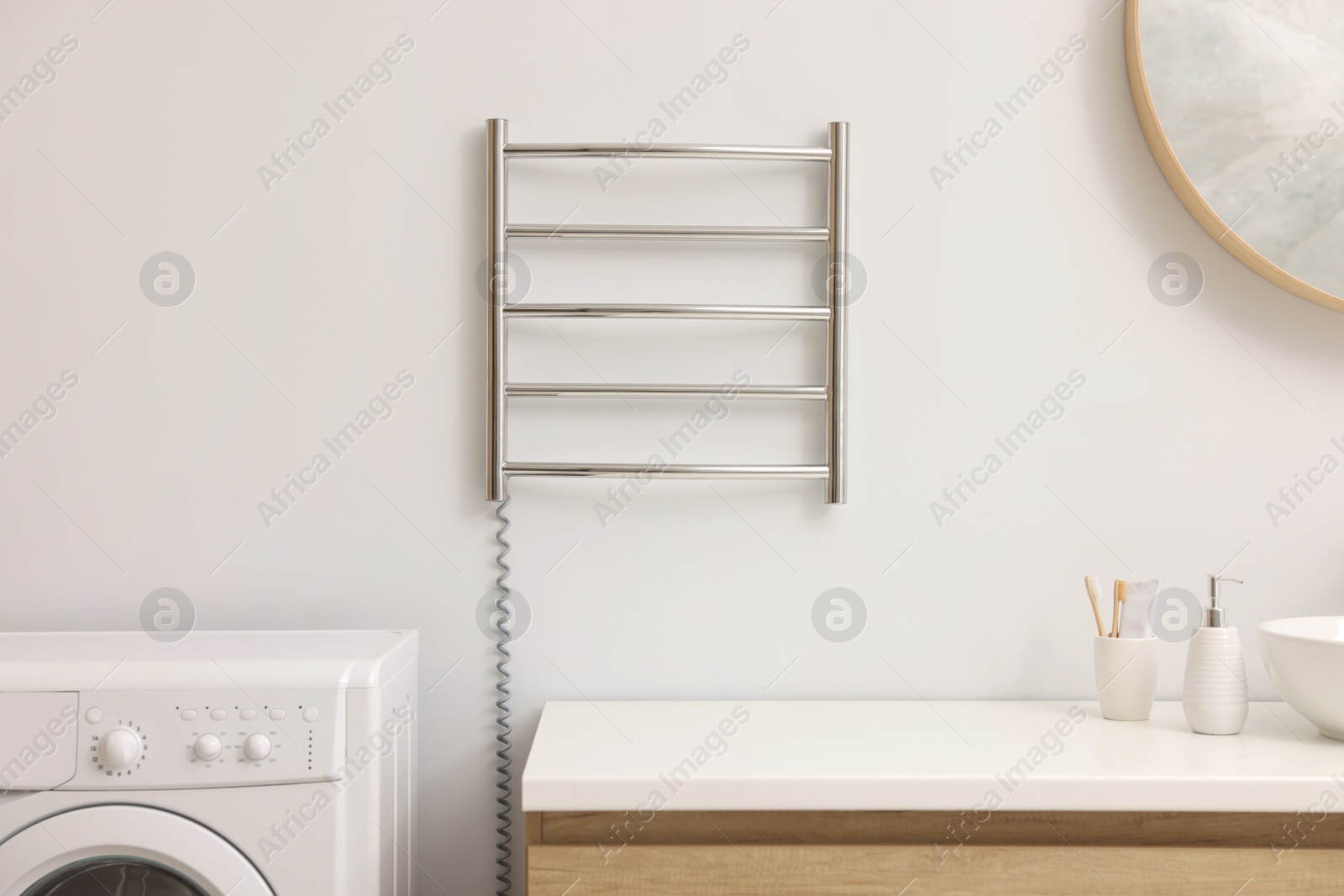 Photo of Stylish bathroom interior with heated towel rail and vanity