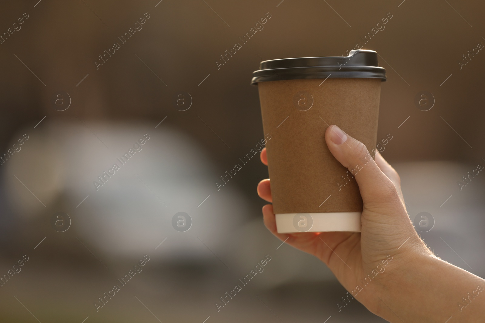 Photo of Woman with takeaway coffee cup outdoors, closeup. Space for text