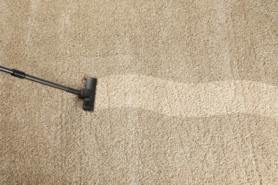 Image of Hoovering carpet with vacuum cleaner, above view and space for text. Clean trace on dirty surface