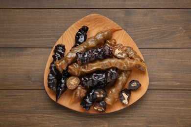 Photo of Delicious sweet churchkhelas on wooden table, top view