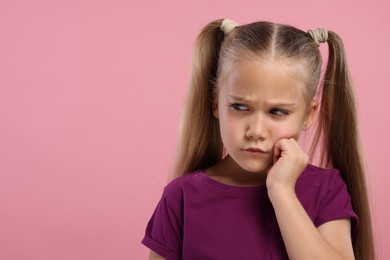 Photo of Resentful girl on pink background. Space for text