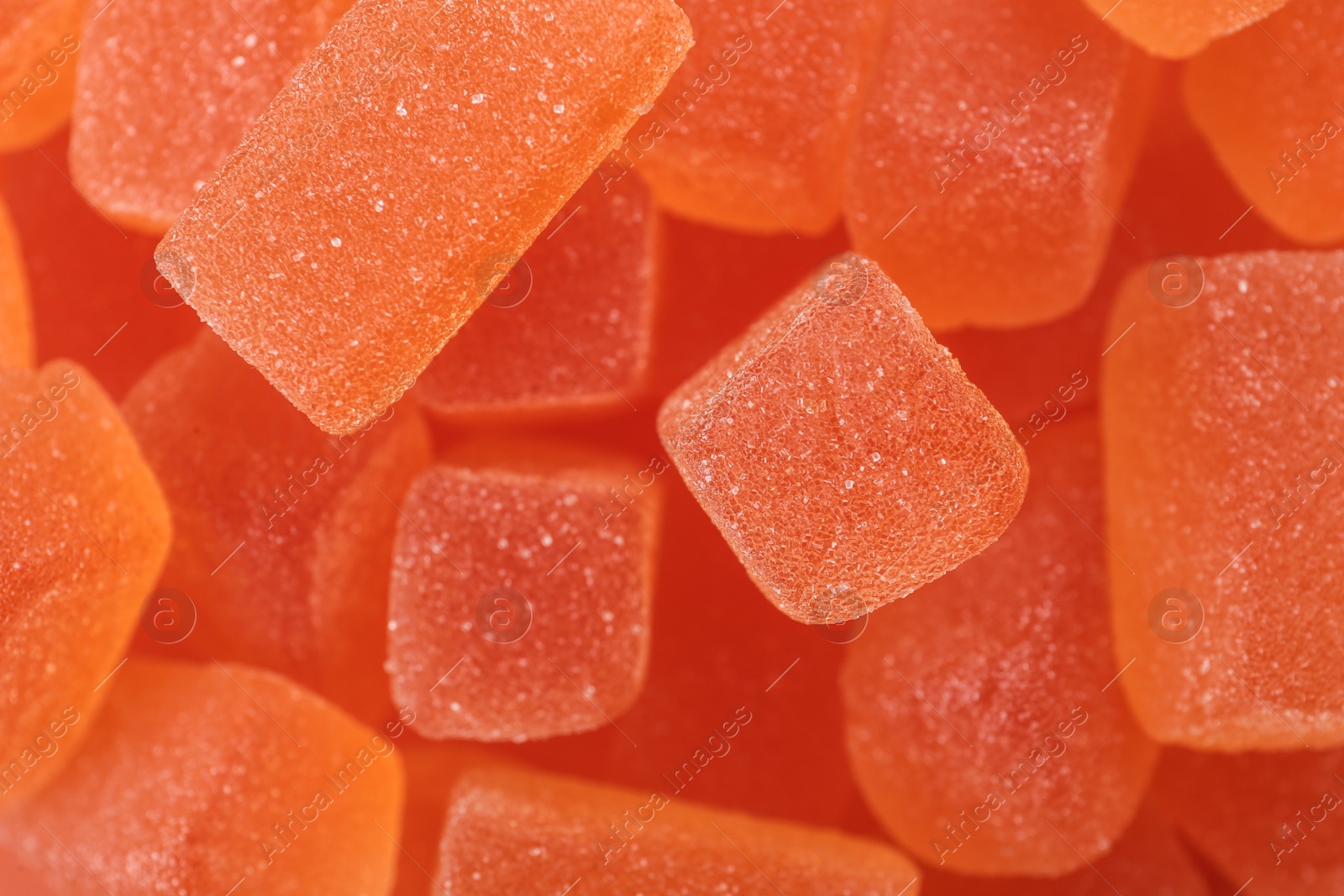 Photo of Tasty orange jelly candies as background, closeup