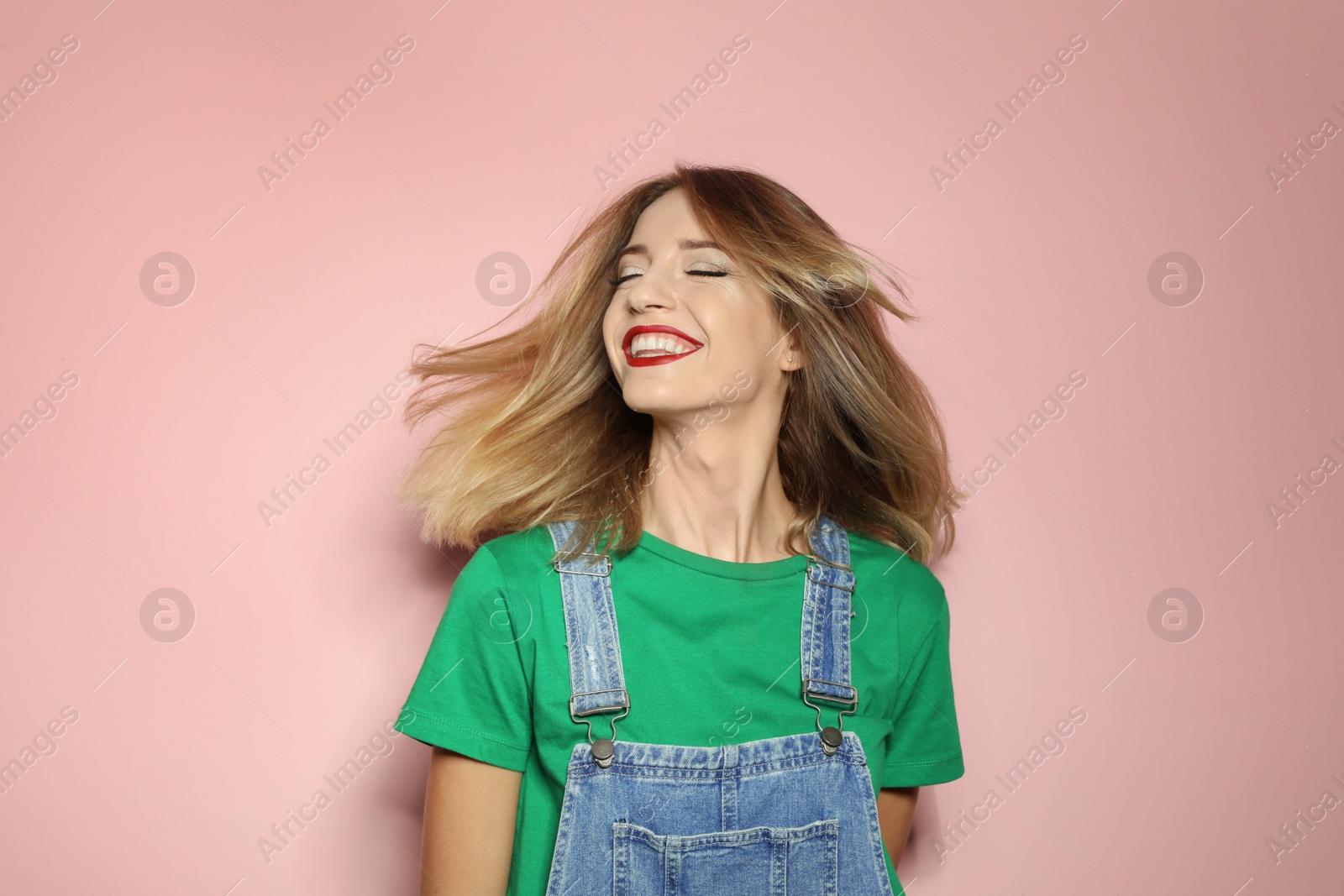 Photo of Beautiful young woman with healthy long blonde hair on color background