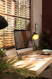 Photo of Comfortable workplace near window in room. Interior design