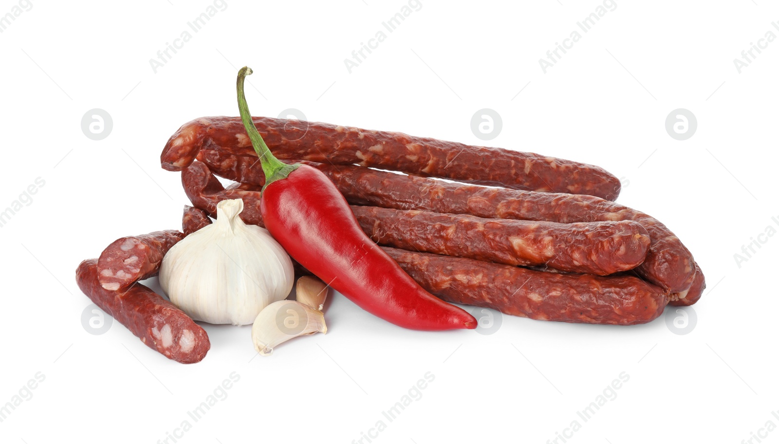 Photo of Thin dry smoked sausages and spices isolated on white