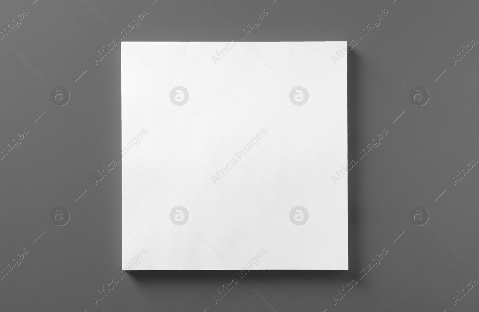 Photo of Stack of blank paper sheets for brochure on light grey background, top view