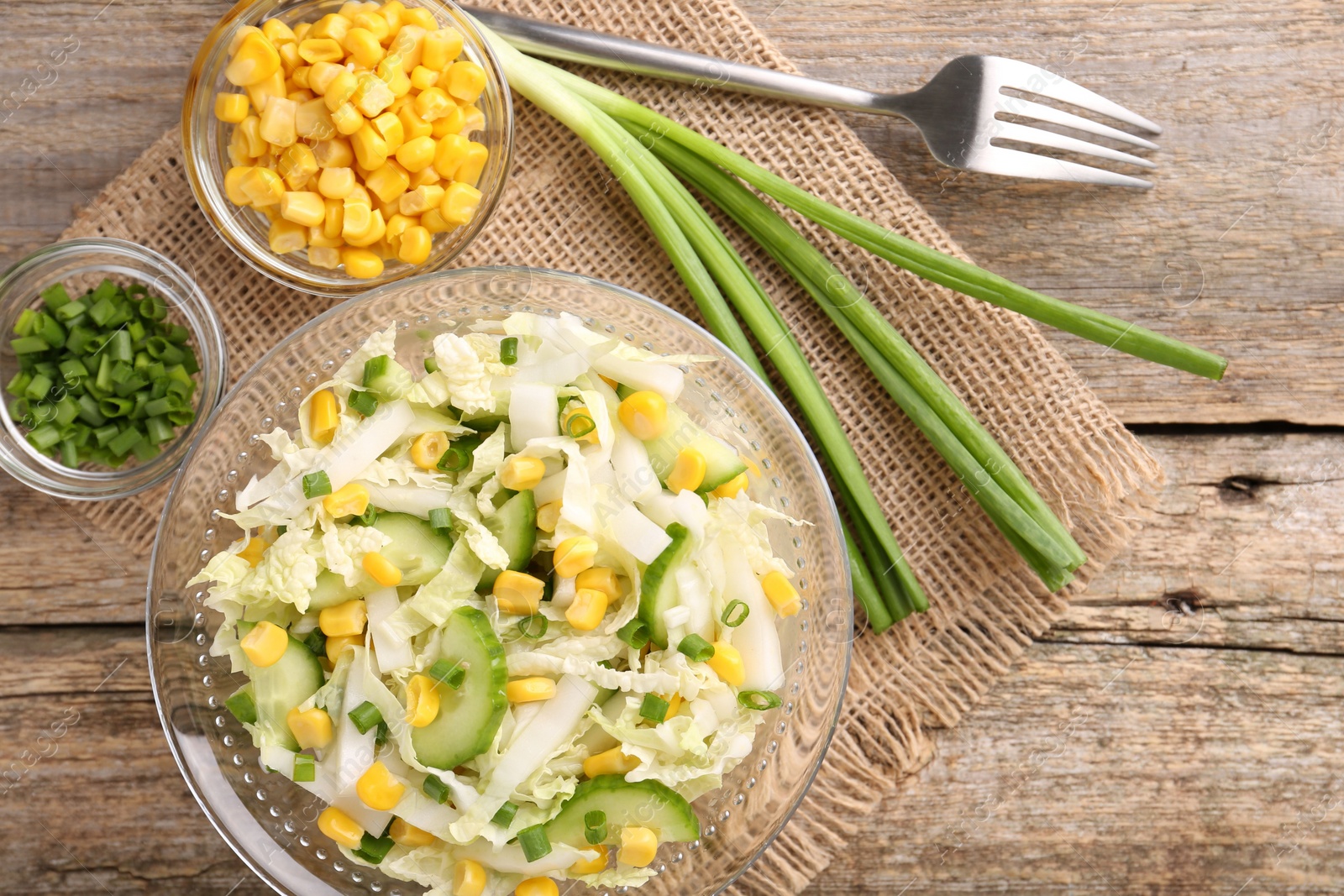 Photo of Tasty salad with Chinese cabbage served on wooden table, flat lay