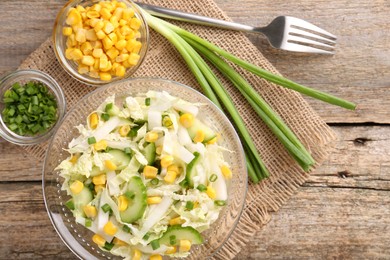 Tasty salad with Chinese cabbage served on wooden table, flat lay