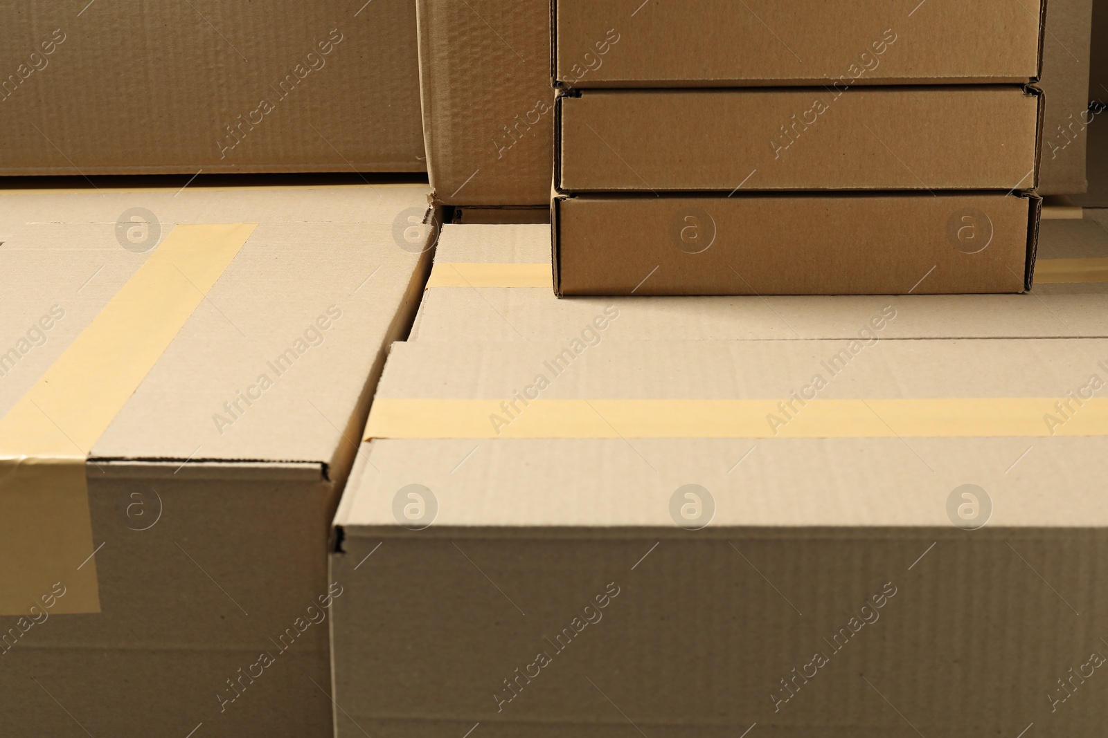 Photo of Many cardboard boxes as background, closeup. Packaging goods