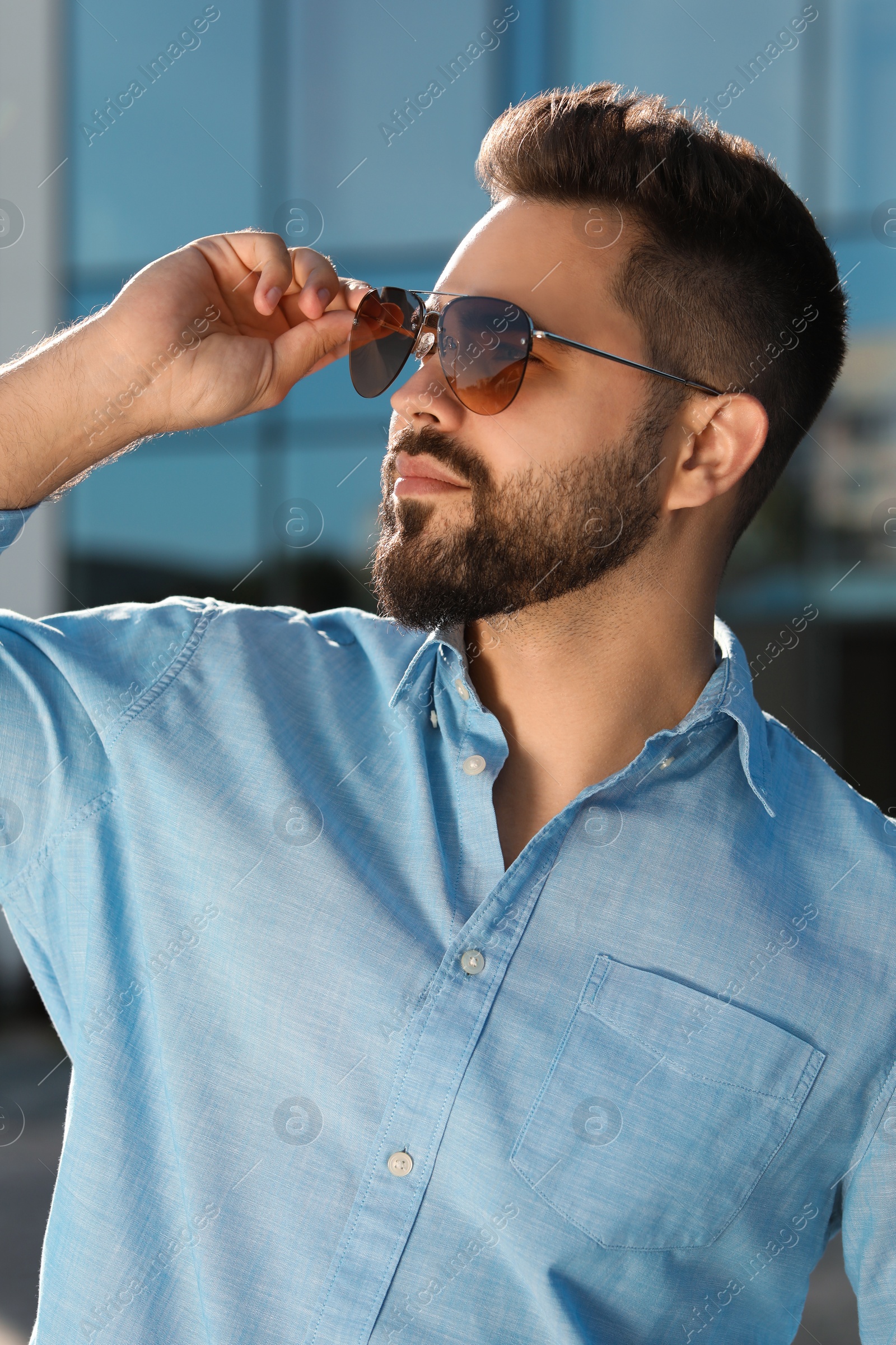 Photo of Handsome man in sunglasses outdoors on sunny day