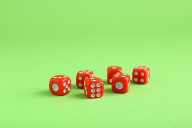 Photo of Many red game dices on green background