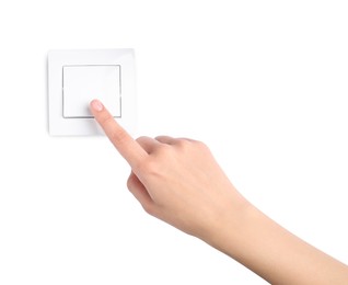 Photo of Woman pressing light switch on white background, closeup