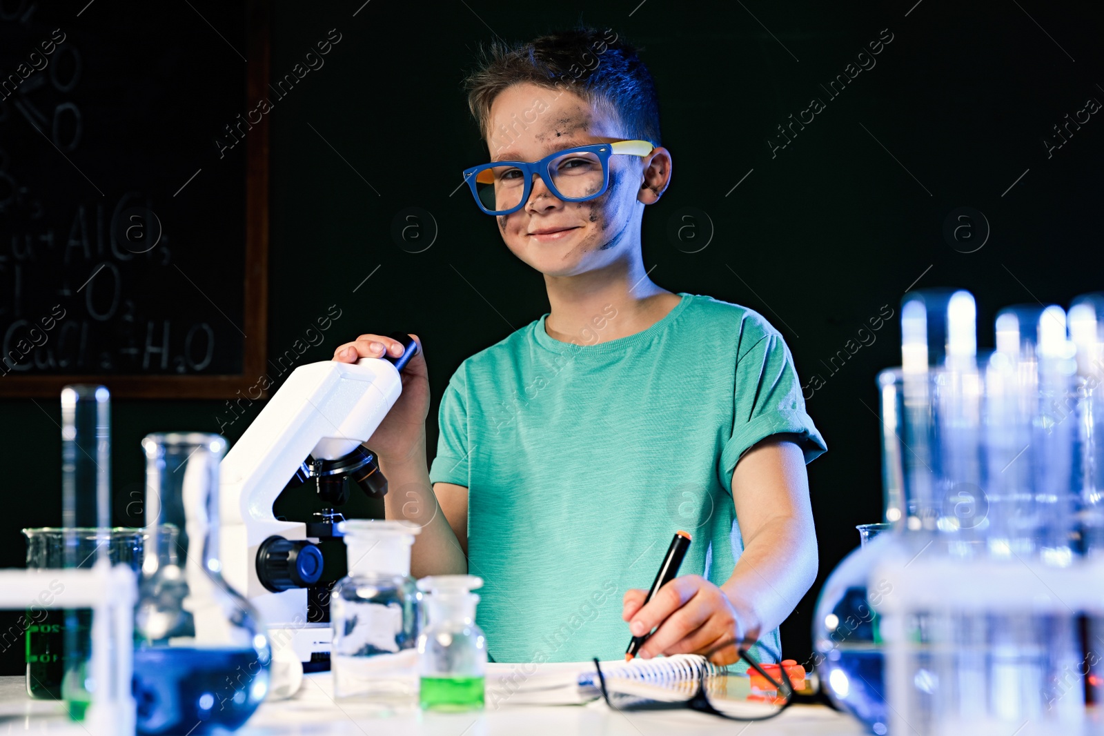 Photo of Child doing chemical research in laboratory. Dangerous experiment