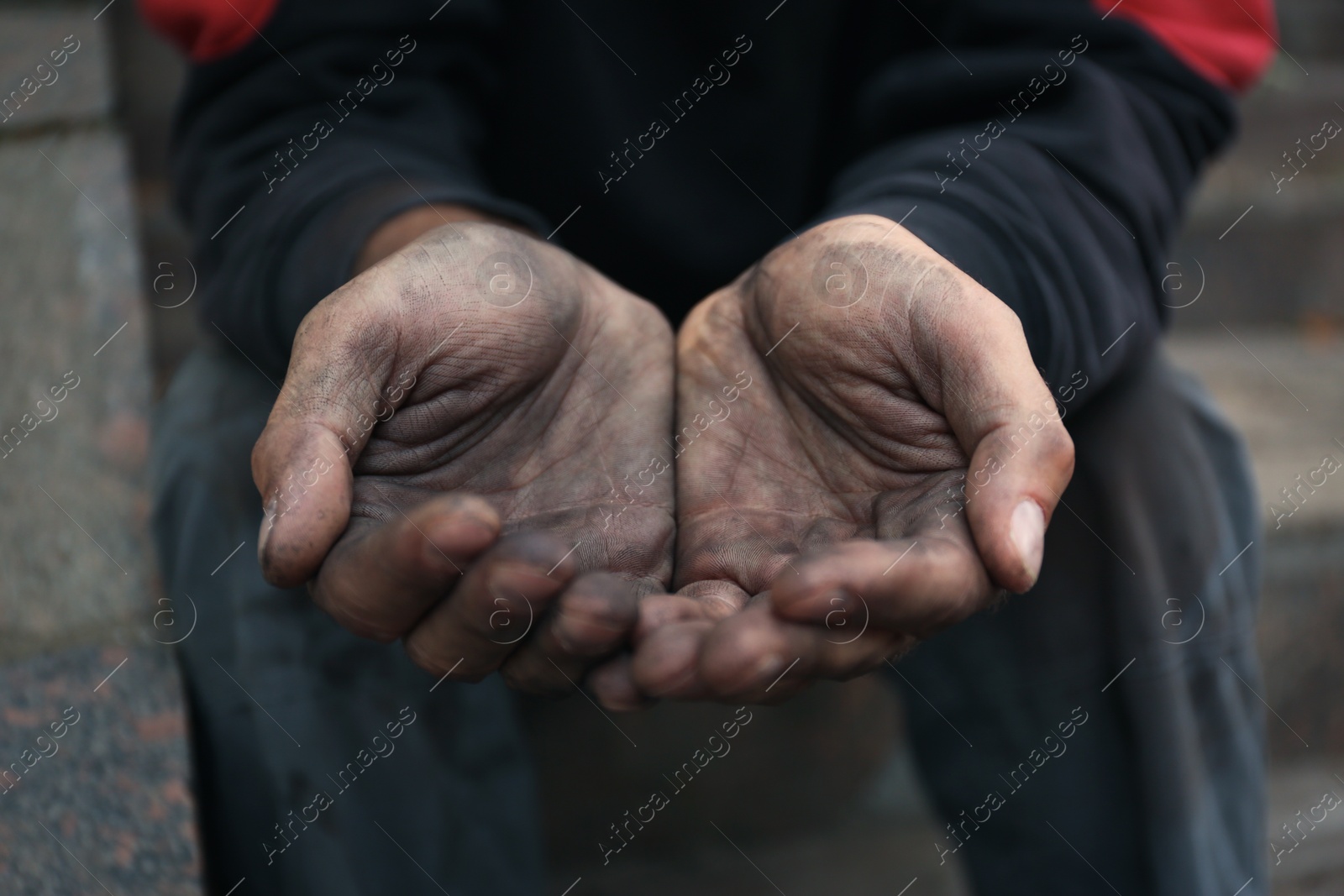 Photo of Poor homeless man begging for help outdoors, closeup